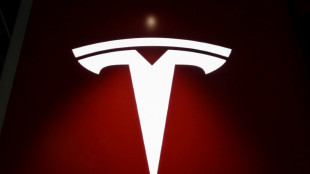 Tesla helps drive stocks mostly higher