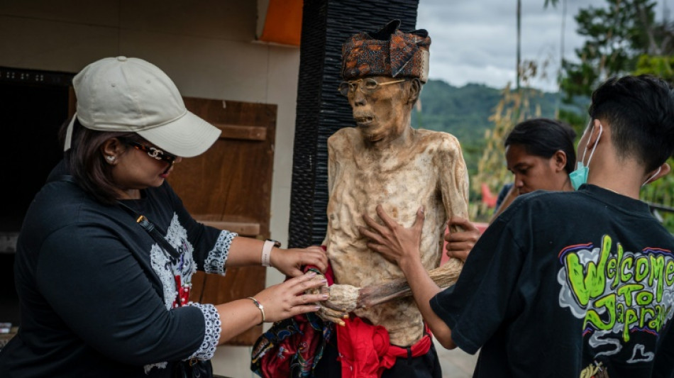 Indonesian villagers dress corpses in ritual for the dead