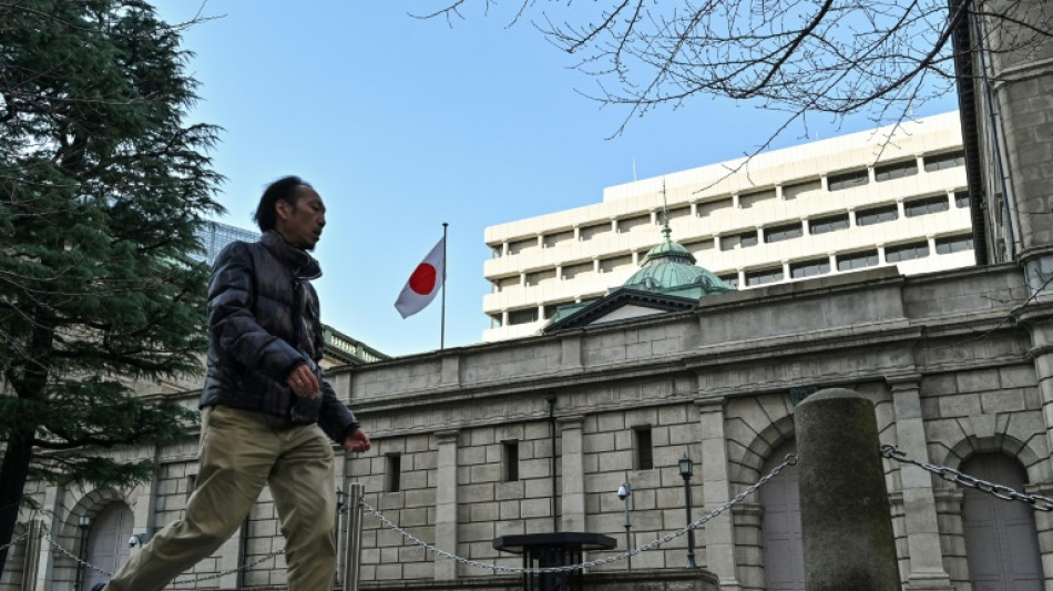 Bank of Japan holds rates, warning of trade uncertainty